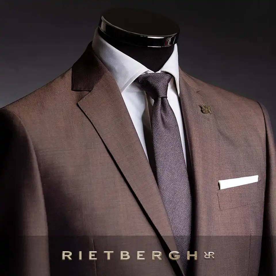 Bruin-maatpak-2026-0001 Bruin maatpak met een bruine das in een andere kleur bruin en een wit shirt en wit pochet van Rietbergh